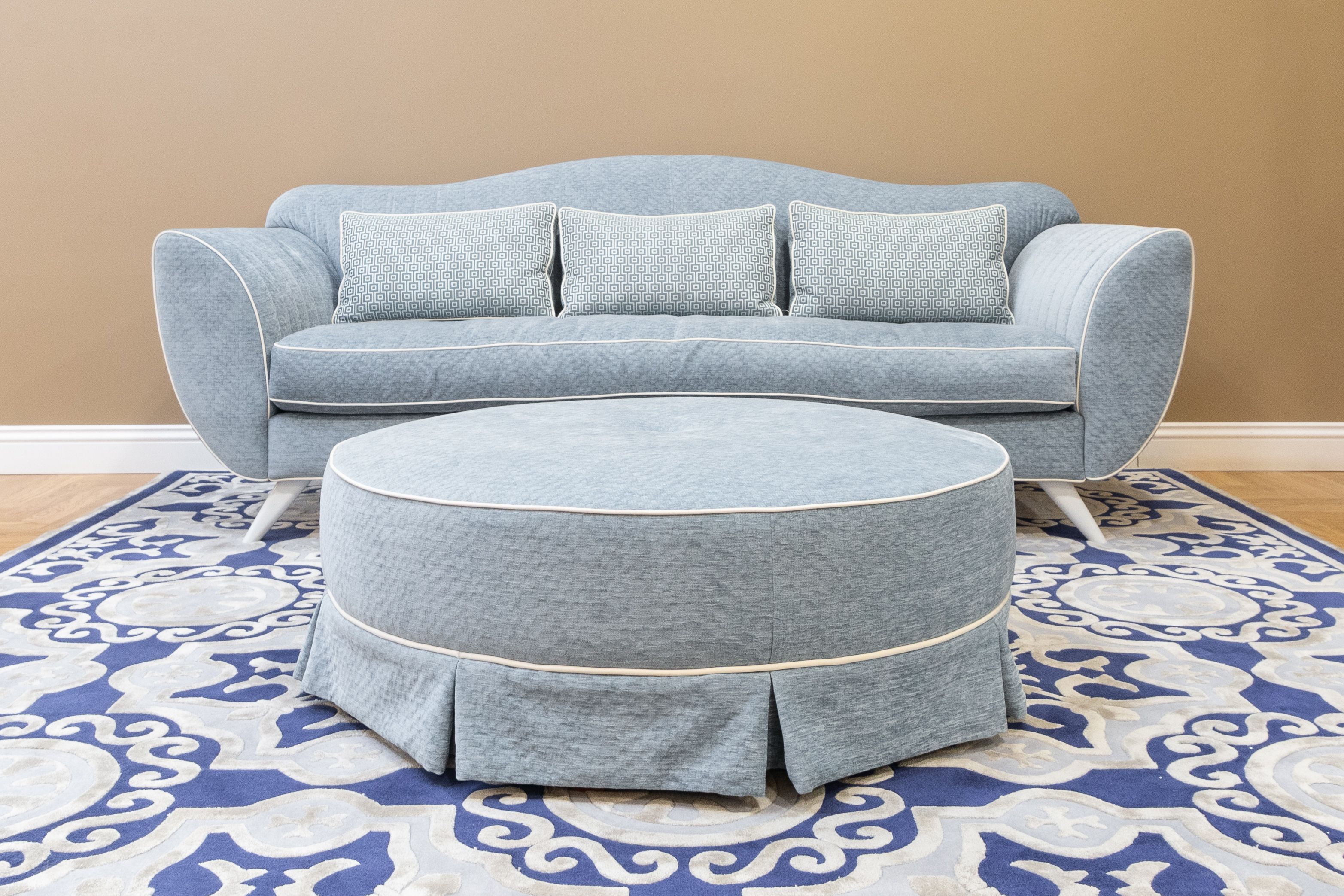 A living room sofa and ottoman, the kind of item people list for sale