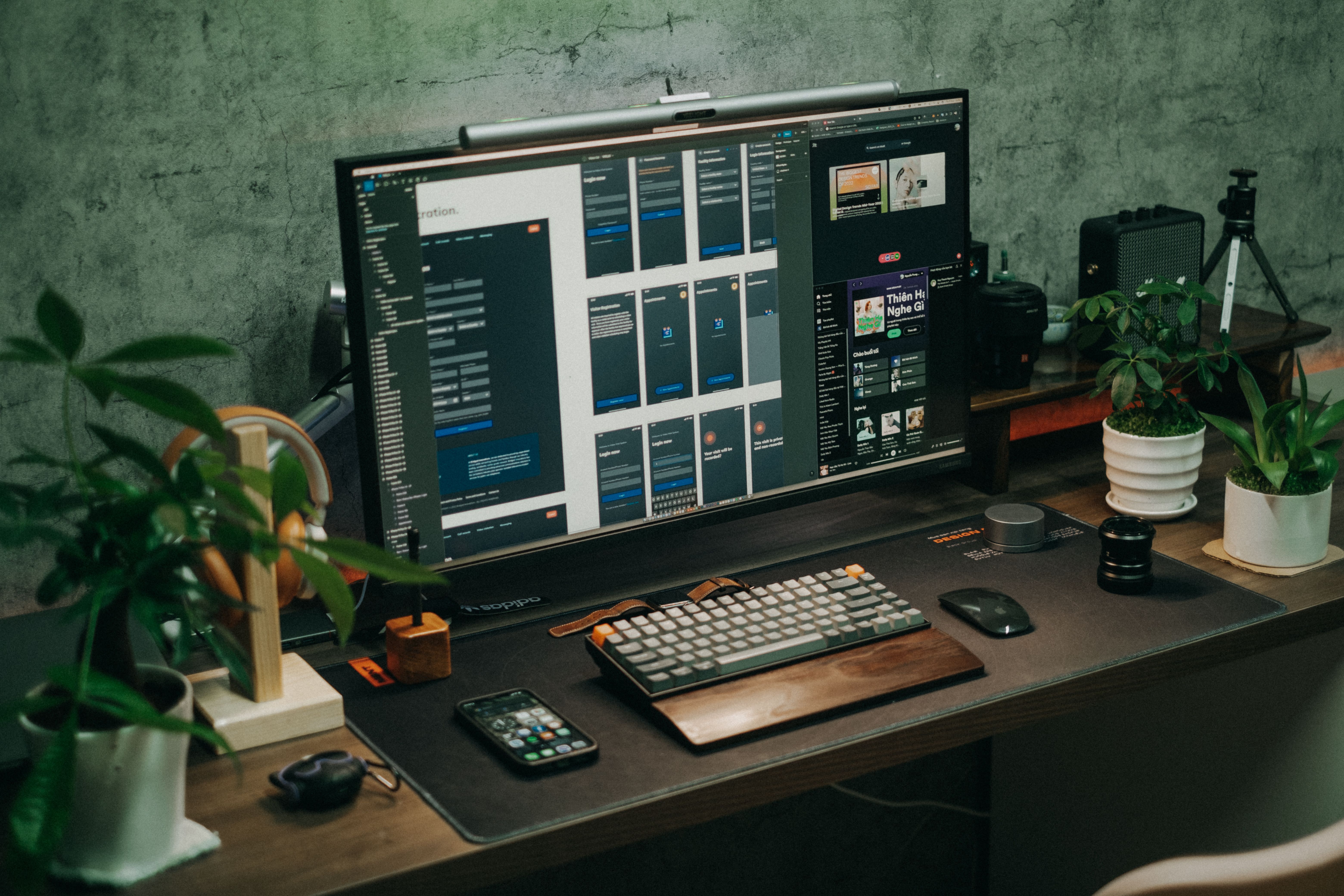Desk workspace with monitor, keyboard and plants