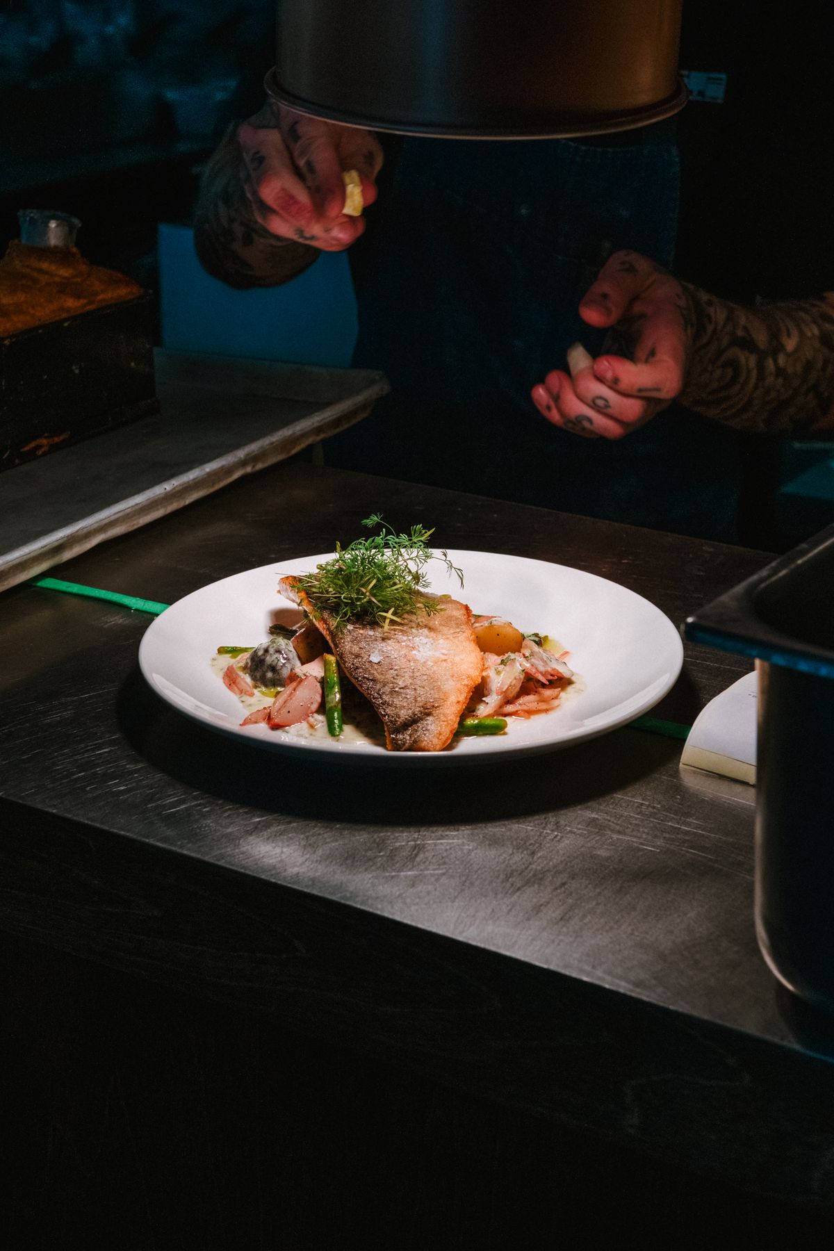 Chef plating a heritage dish in the kitchen