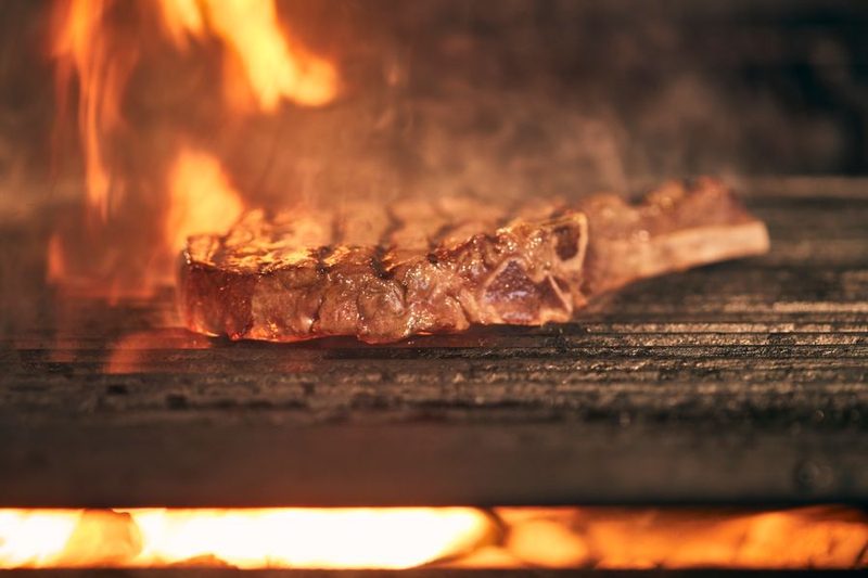 Steak sizzling over an open flame