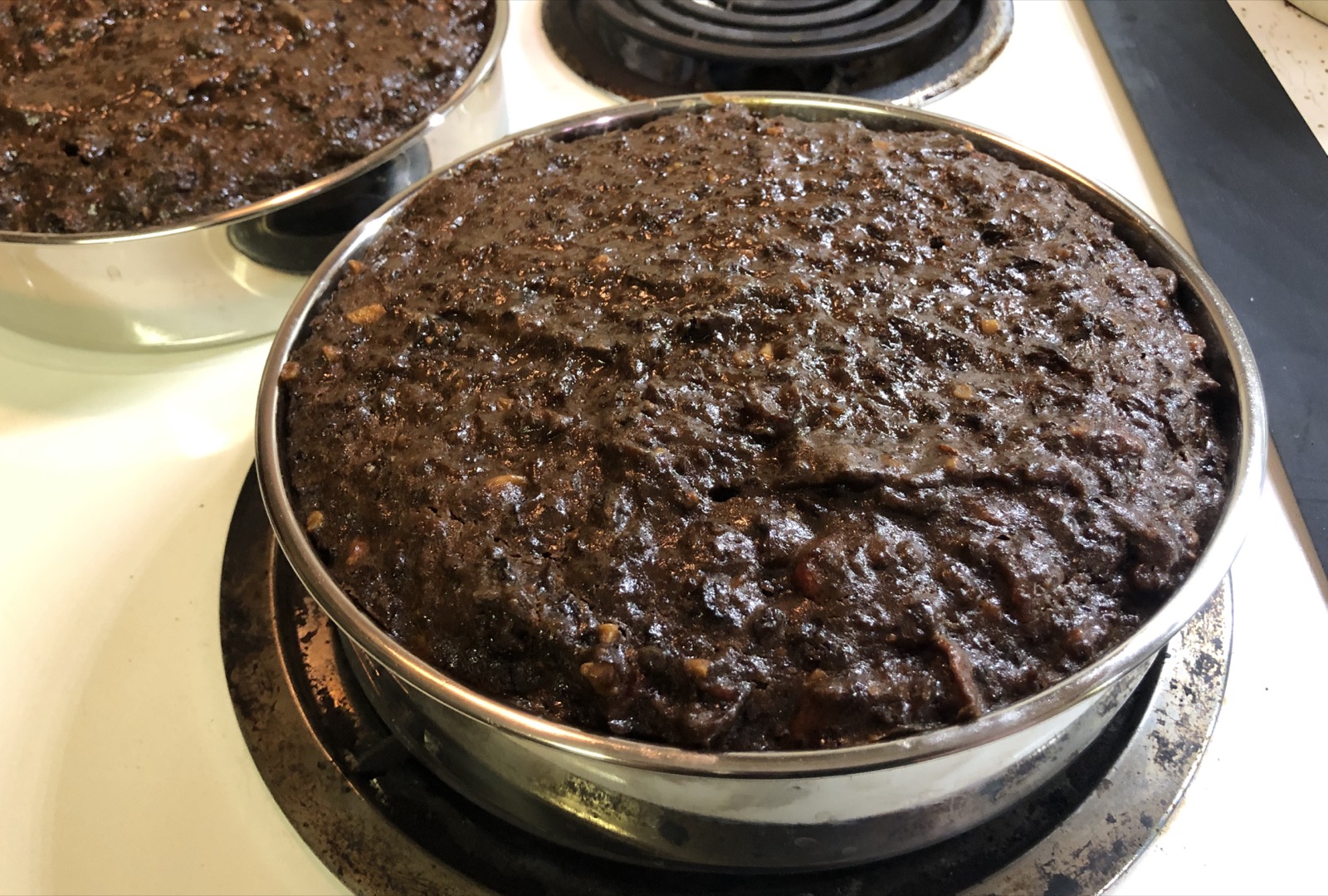 Freshly baked Guyanese black cake cooling in the pan