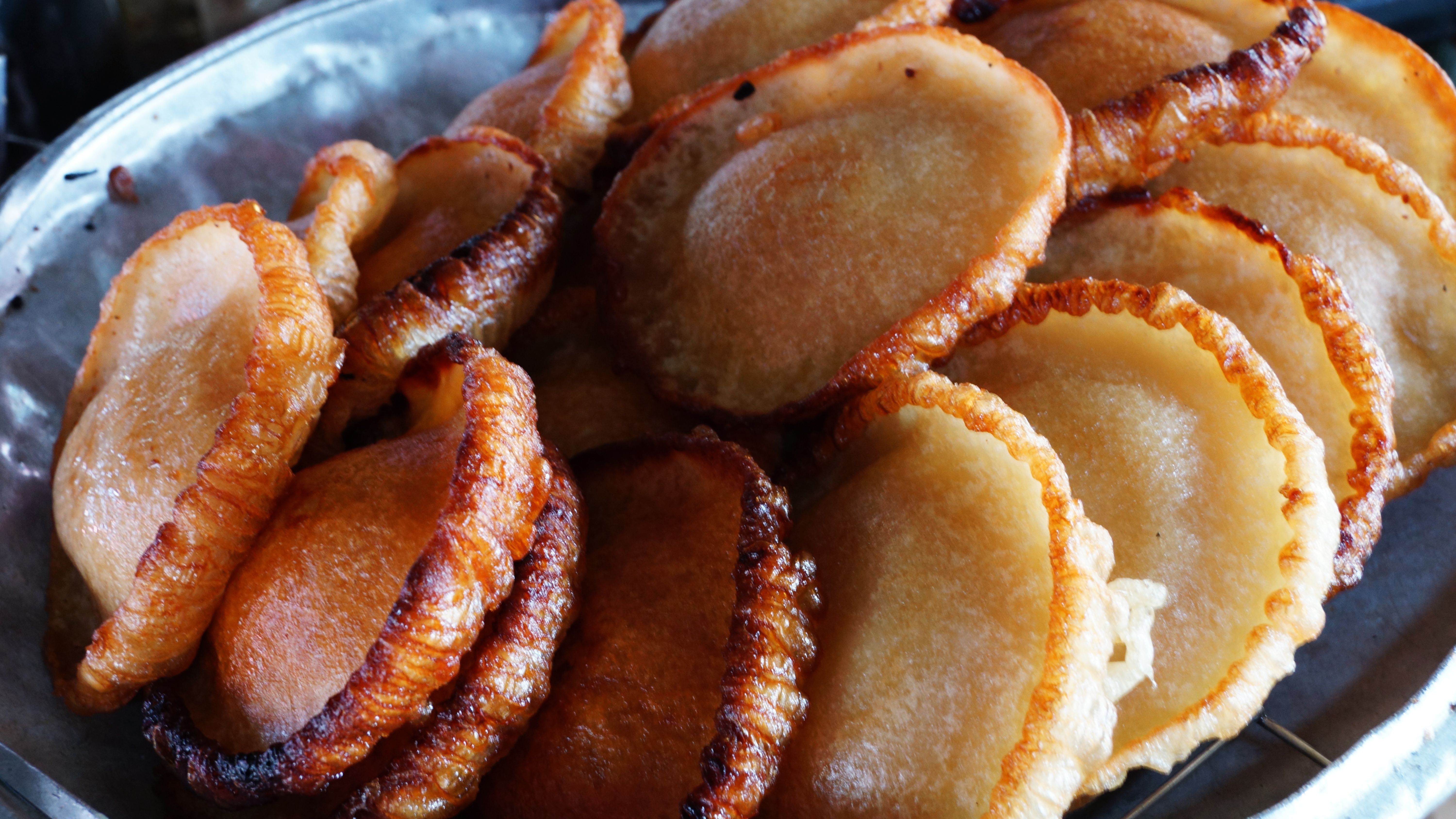 A tray piled with freshly fried Guyanese bakes
