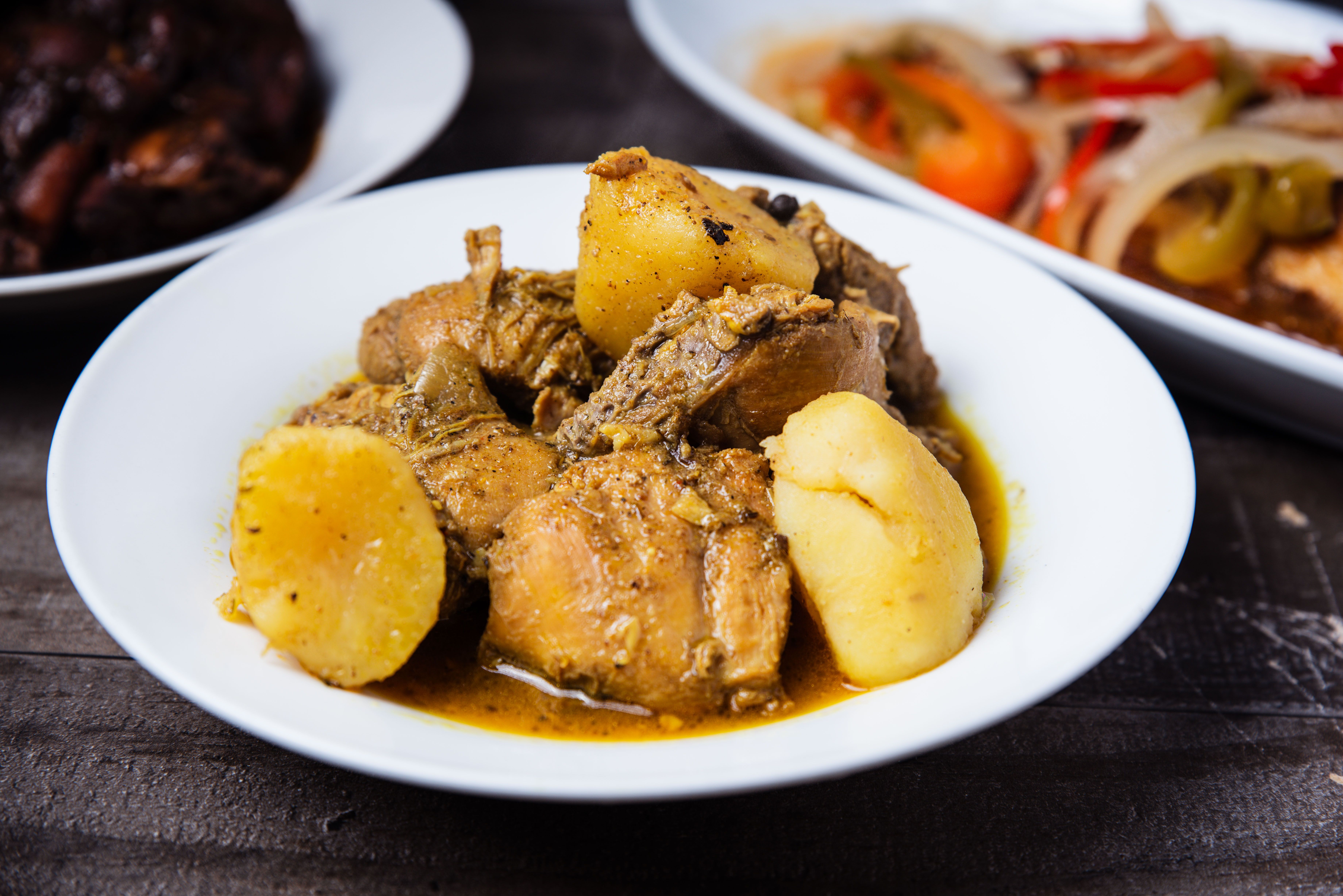 A bowl of curry chicken with potatoes