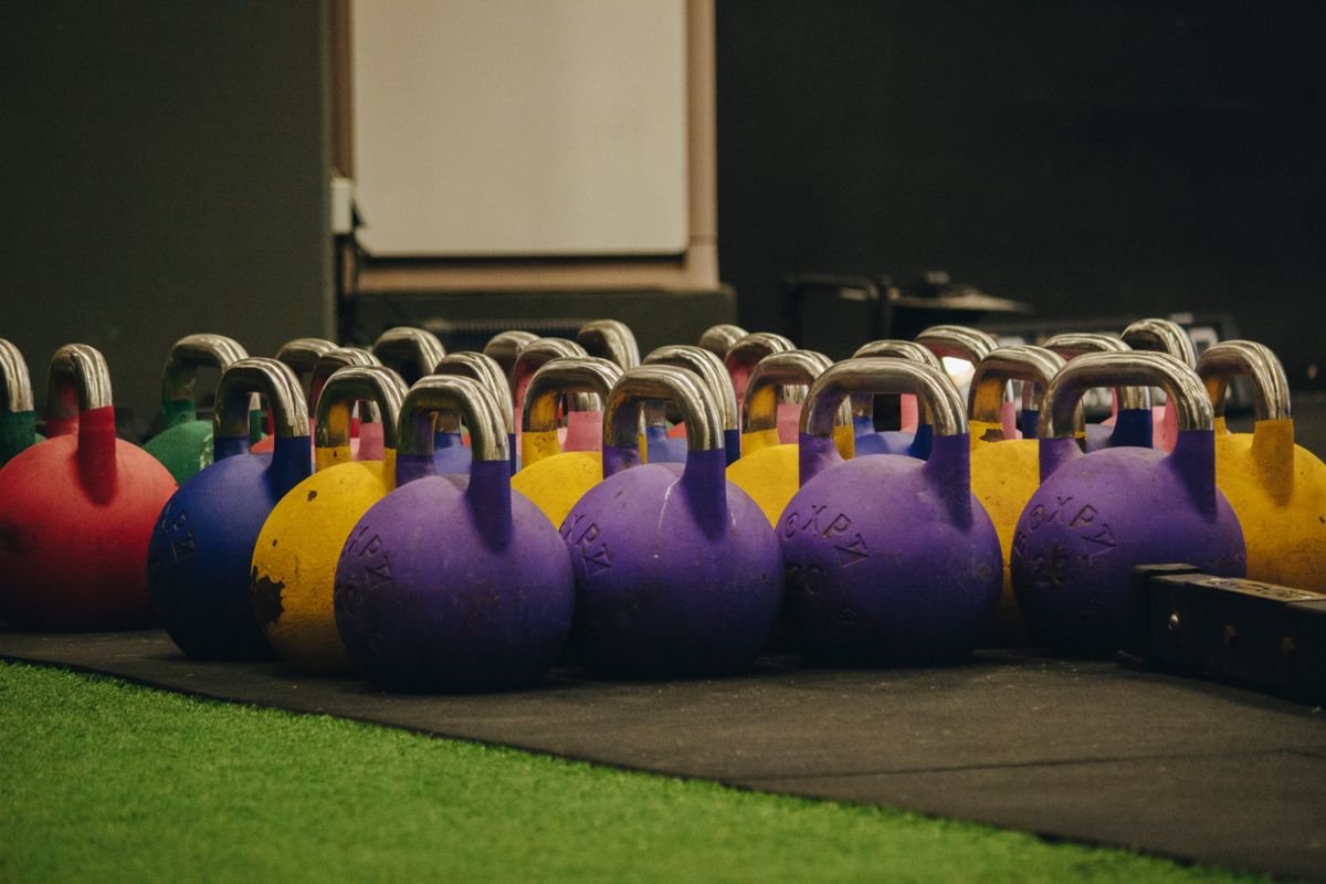 Rows of colorful kettlebells lined up for functional training